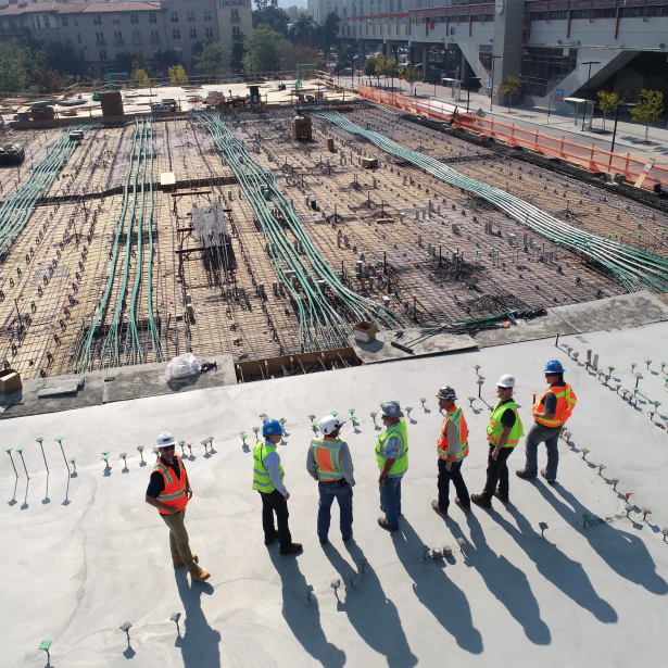 people lined up while observing the construction site